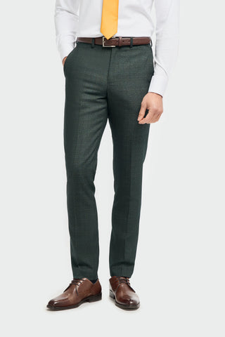 Green pants worn by a person with a plain background