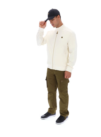 Man wearing a white jacket and green pants on a white background
