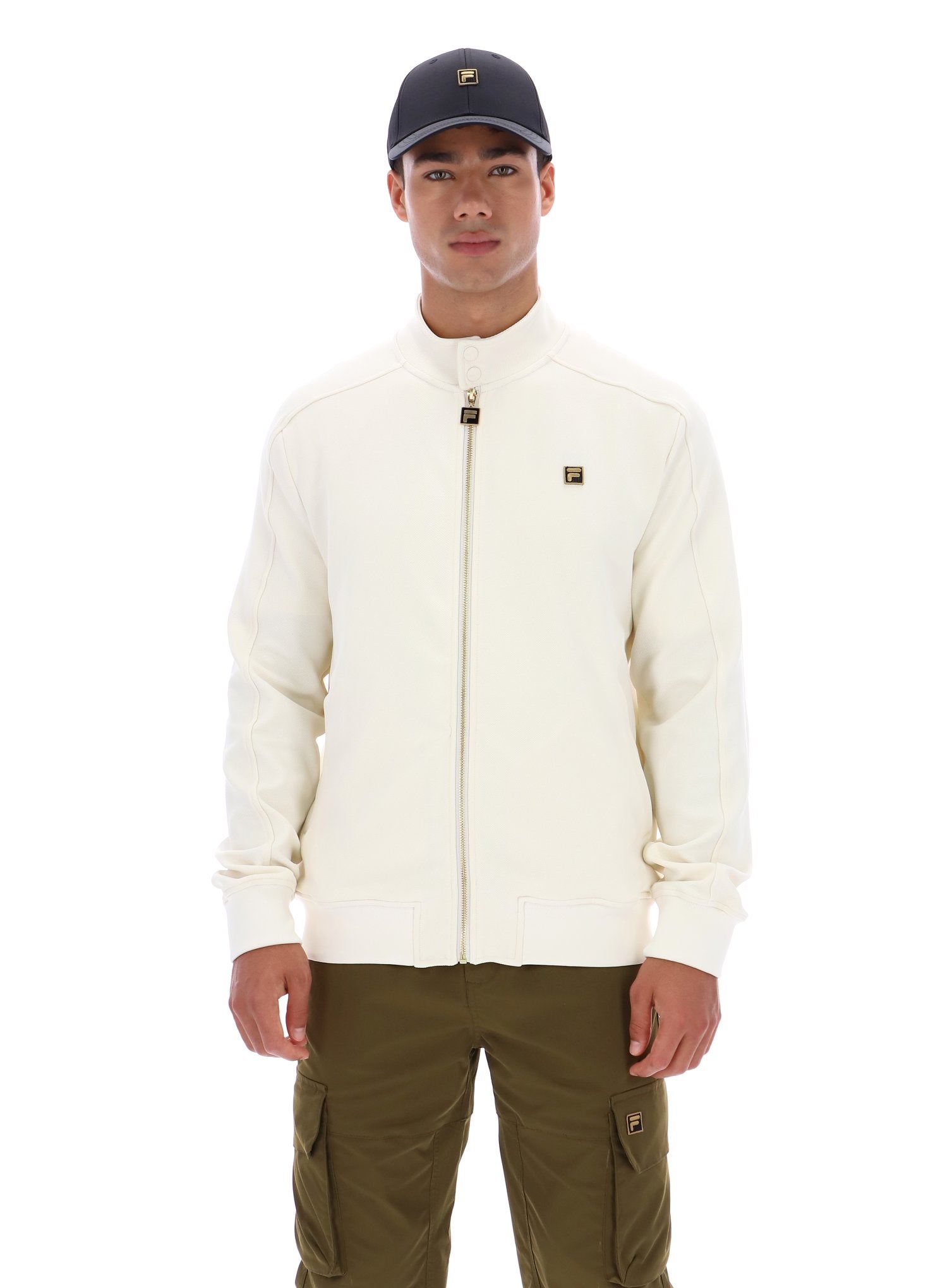 Man wearing a cream jacket and green cap on a white background