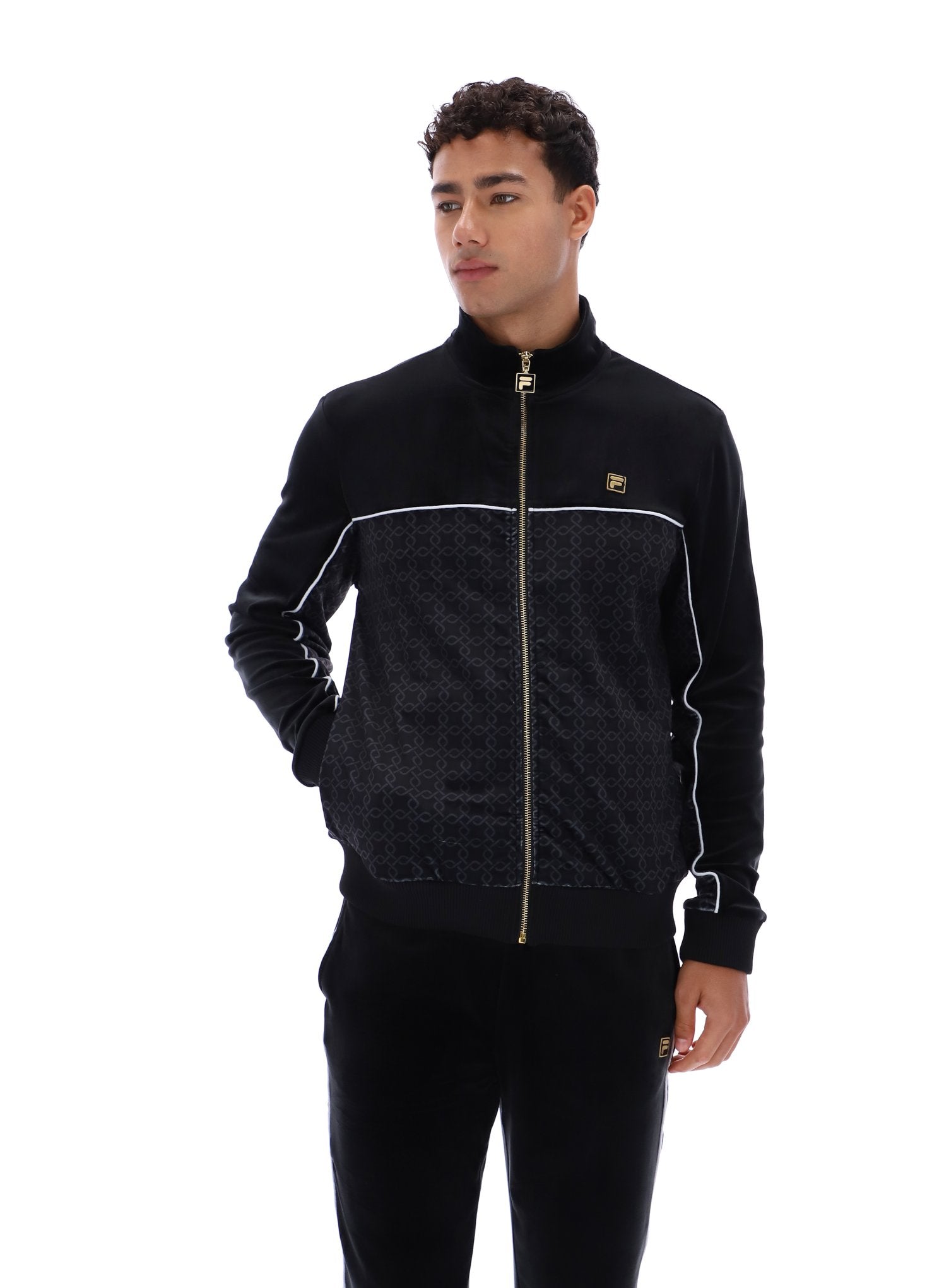 Man wearing a black tracksuit with white accents on a white background