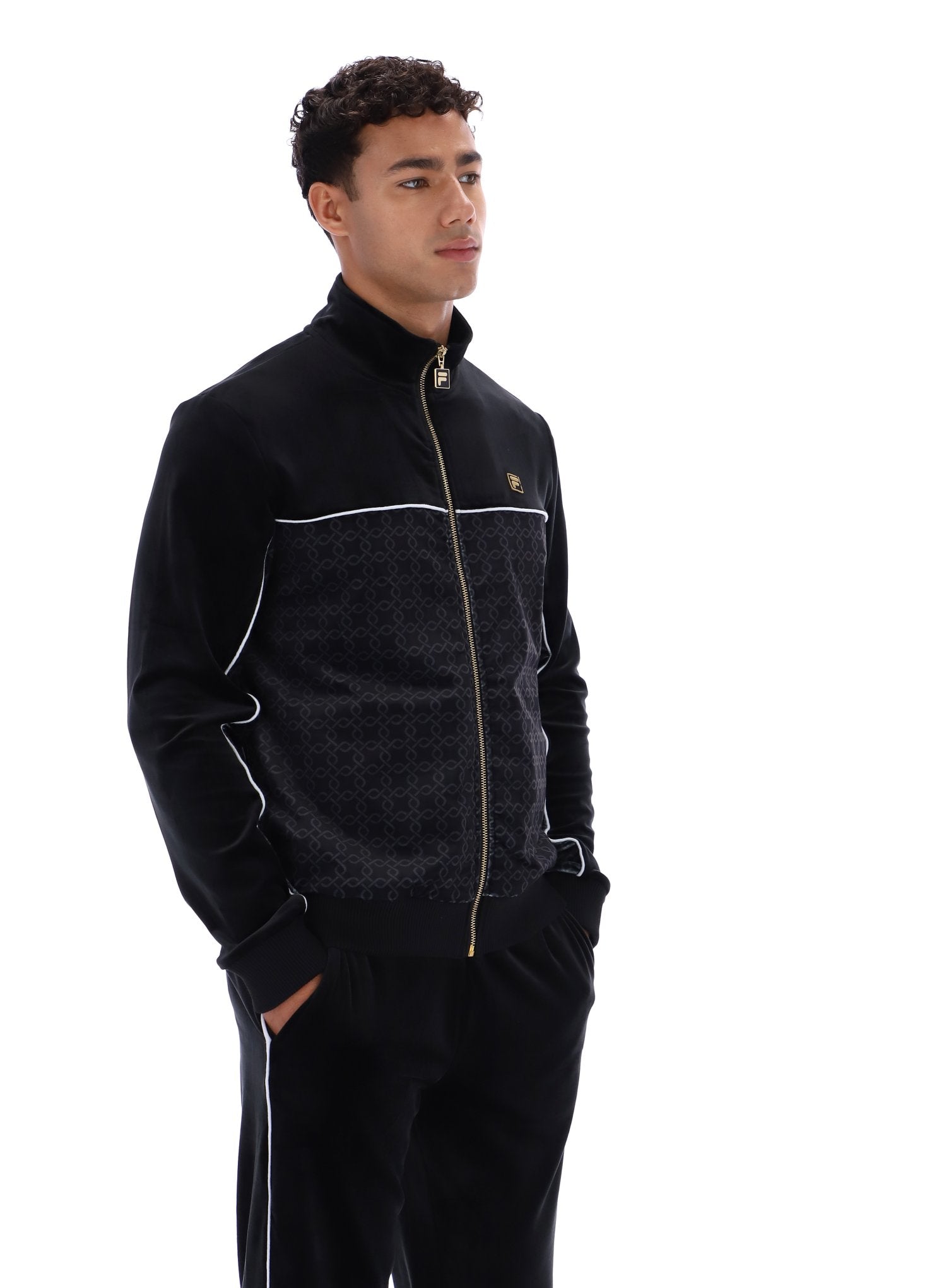 Man wearing a black tracksuit with white accents on a white background