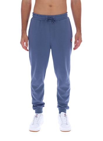 Blue sweatpants worn by a person on a white background