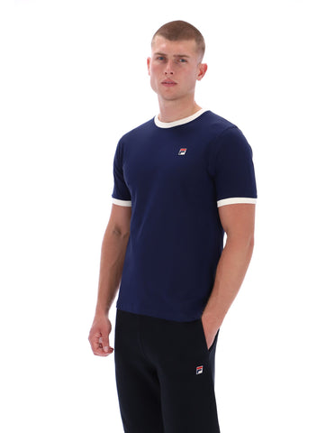 Man wearing a navy blue t-shirt with white trim and a small logo on a white background