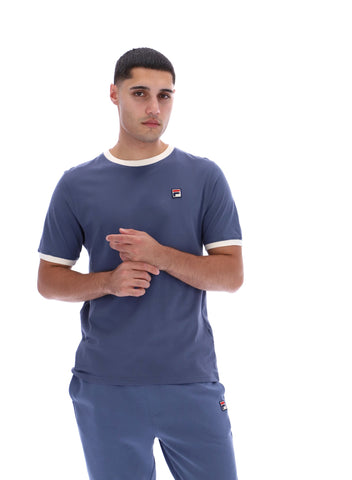 Man wearing a blue t-shirt with a logo on a white background