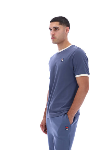 Man wearing a blue t-shirt and pants with a logo on a white background