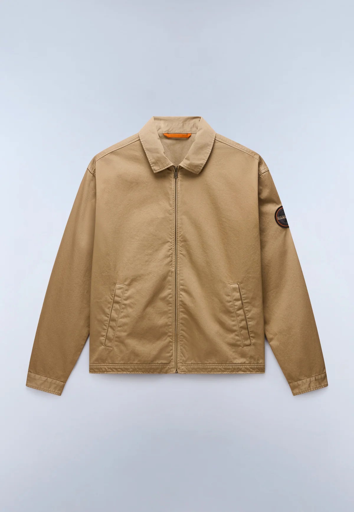Beige jacket on a light blue background