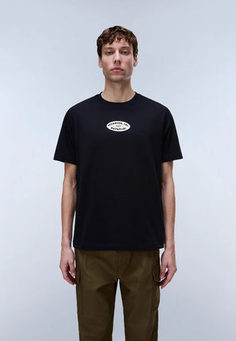 Man wearing a black t-shirt with a logo on a light gray background