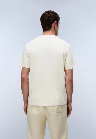 Man wearing a light-colored t-shirt and pants against a plain background