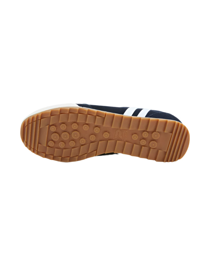A pair of white Patrick Villan trainers with a lace-up front, rubber outsole, and gold signature logo.