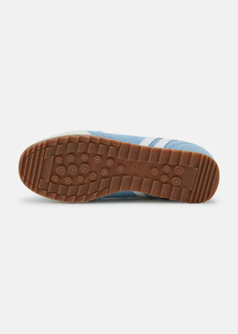 A pair of sky blue and white Patrick Rio trainers with a suede upper and a rubber sole, featuring white stripes and a gold logo.