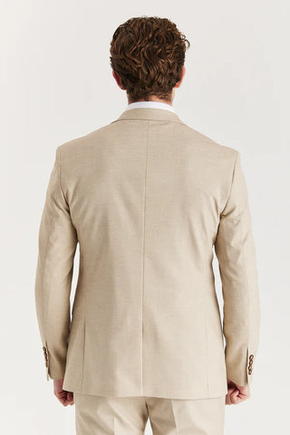 Man wearing a beige suit jacket on a white background