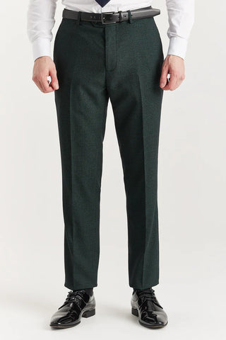 Dark green dress pants worn by a person on a white background