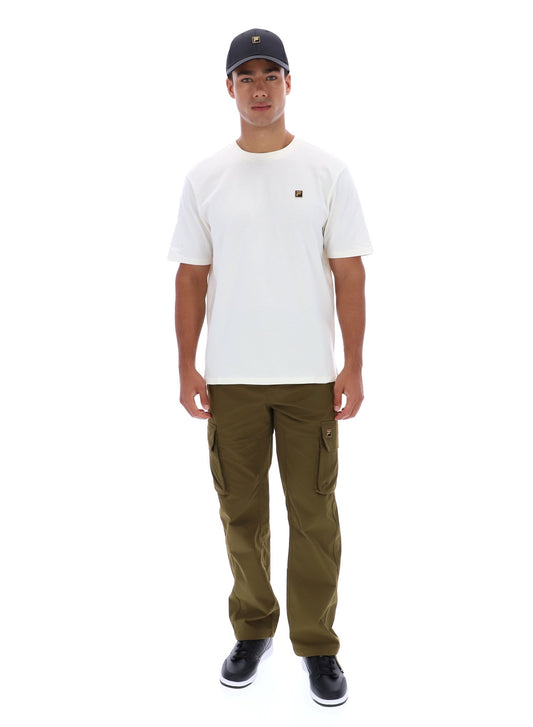 Man wearing white t-short, khaki trousers, and a black baseball cap on a white background