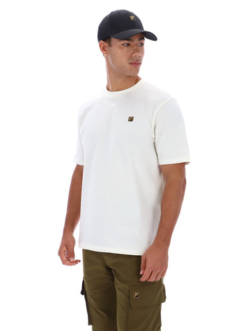 Man wearing white t-short, khaki trousers, and a black baseball cap on a white background