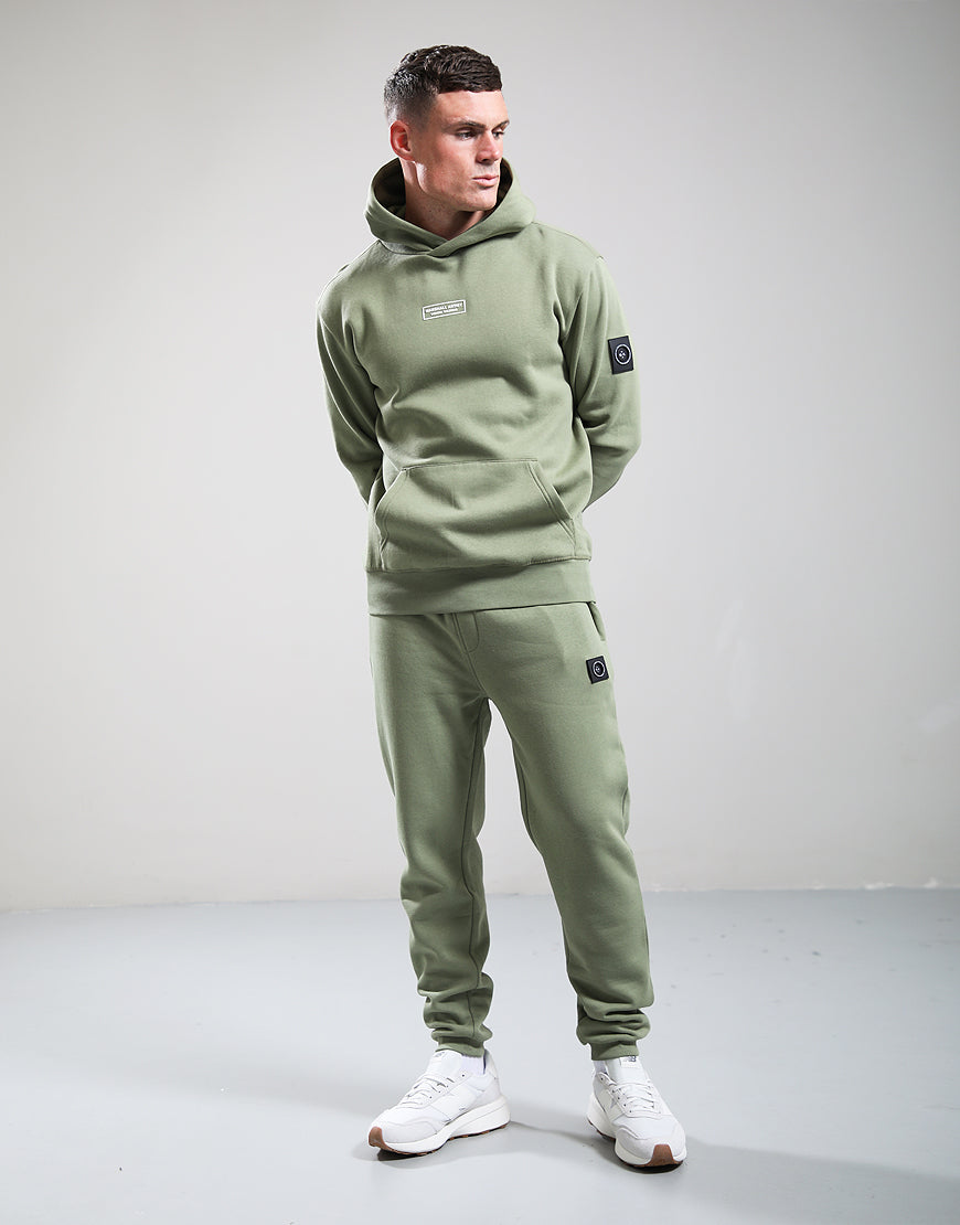 Man wearing a green tracksuit with a plain background