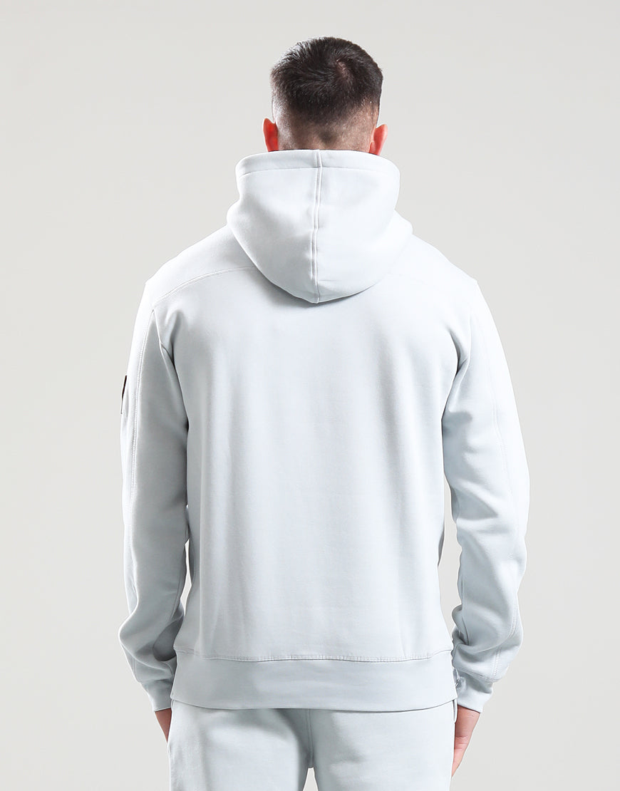 Person wearing a light gray hoodie and pants on a plain background