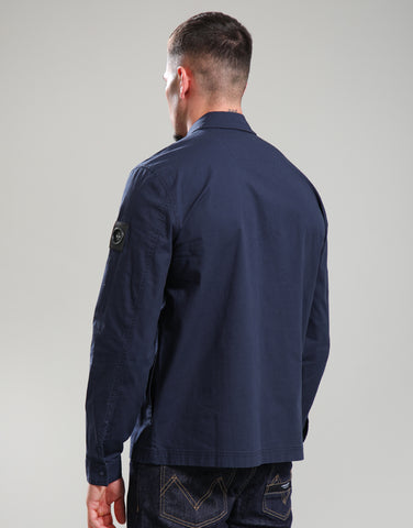 Man wearing a navy blue jacket on a plain background